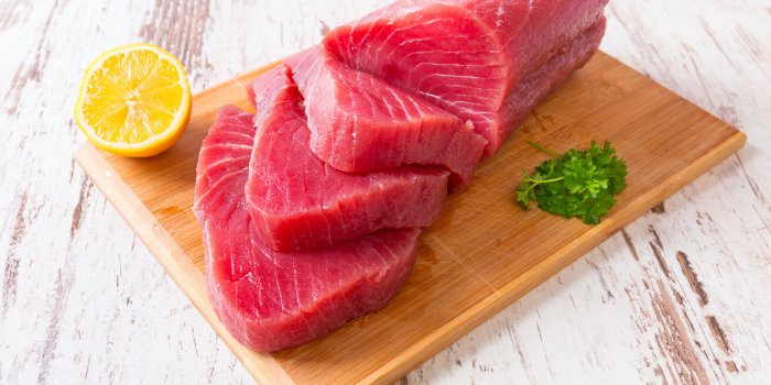 raw tuna steak on wooden cutboard