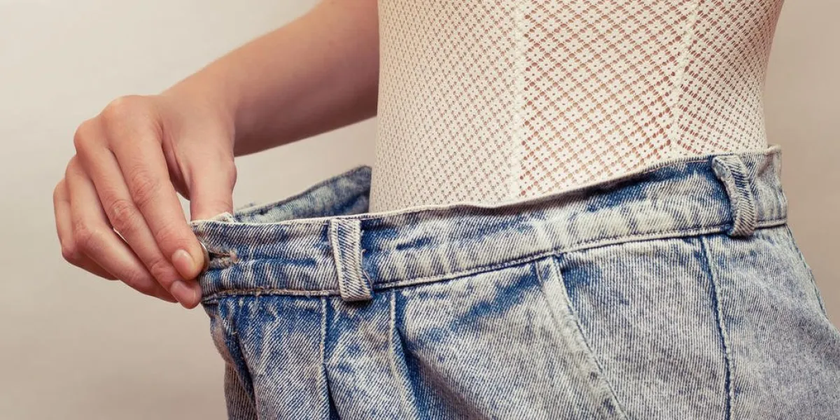 woman dressed over size blue old style jeans, copy space