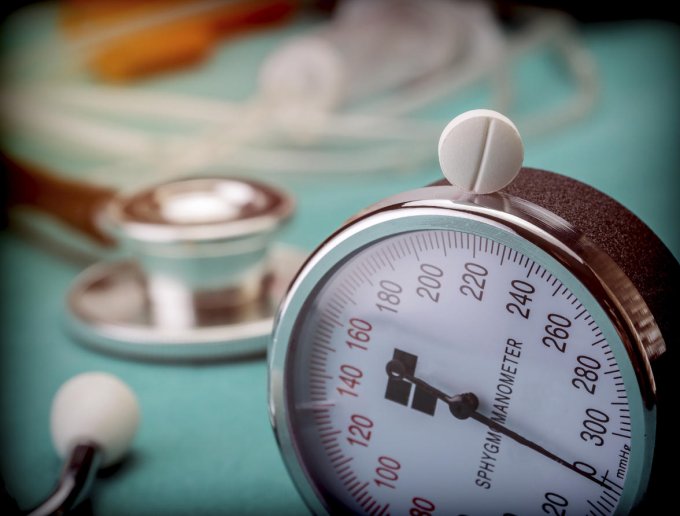white pad next to a manometer to measure blood pressure and a stethoscope in a hospital, conceptual image