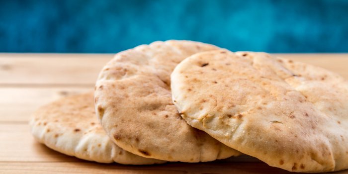 pita, arabic bread, soft baked flatbreads on wooden background, selective focus