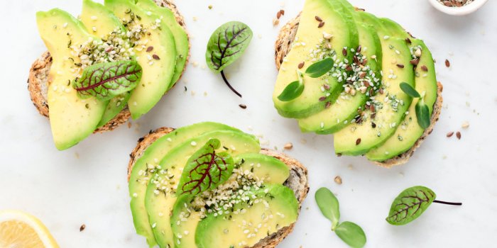 avocado slices with seeds and micro greens on toasted bread on white background healthy vegan vegetarian avocado toasts, ...