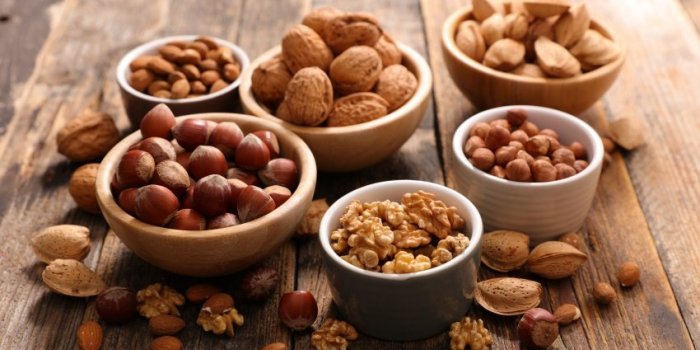 assorted nuts on wood background