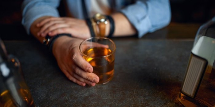 drunk man pours alcohol at the counter in bar one male person resting in pub, human emotions and leisure activities, depr...