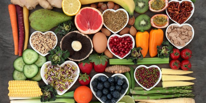 super food concept for a healthy diet with fruit and vegetables, dairy, spices, nuts, legumes, cereals and grains, high i...