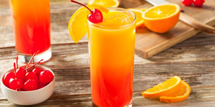 juicy orange and red tequila sunrise with a cherry