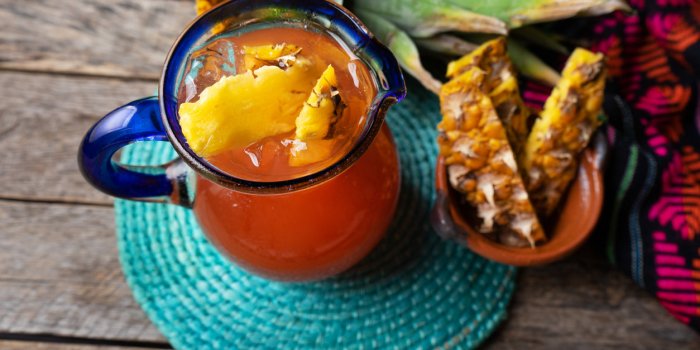 traditional mexican fermented beverage called tepache made with pineapple and cinnamon