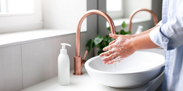 woman washing hands under water tap self care and hygiene close up of female hand infection prevention liquid antibacteri...