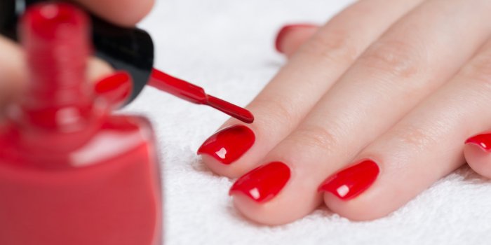 beauty treatment photo of nice manicured woman fingernails with red nail polish