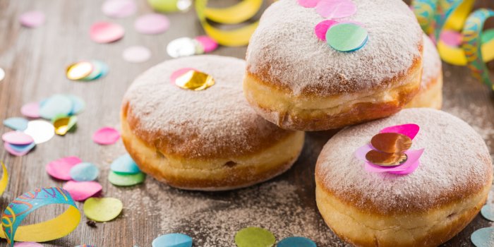 krapfen, berliner or donuts with streamers and confetti colorful carnival or birthday image