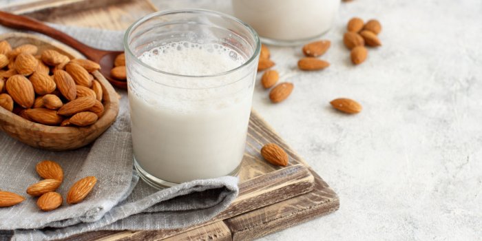 vegan almond milk, non dairy alternative milk in a glass close up