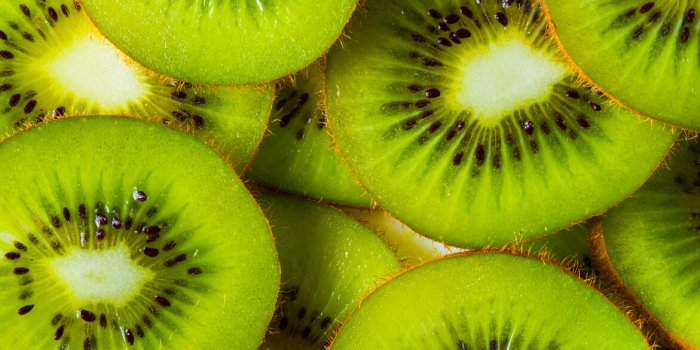 background made with a heap of sliced kiwis