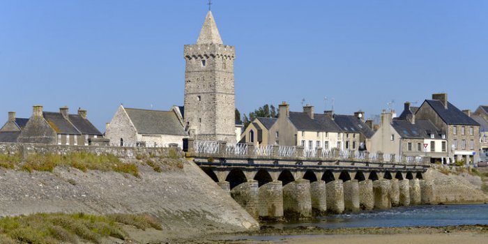 church of notre-dame and old bridge at port-bail or porbail, a commune in the peninsula of cotentin in the manche departm...
