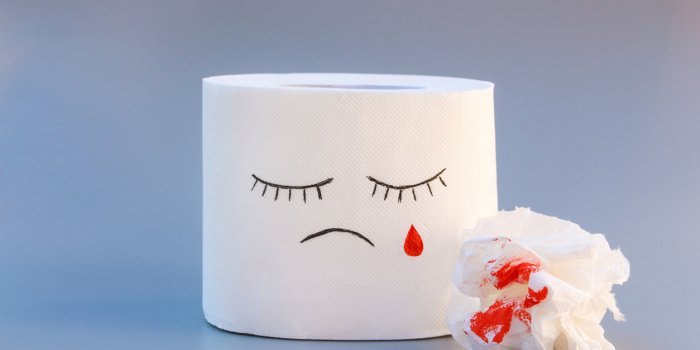 toilet paper and blood concept of hemorrhoid treatment