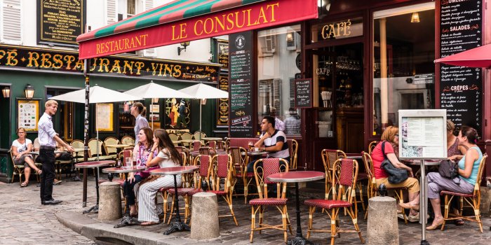 paris, france - july 06, 2017 the charming restaurant le consulat on the montmartre hill parisians and tourists enjoy fo...