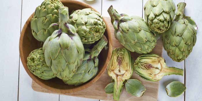 fresh artichokes on the table of the kitchen to be cooked