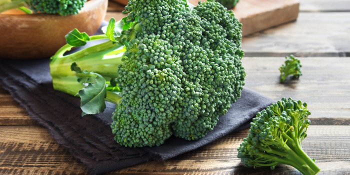 healthy green organic raw broccoli on wooden table