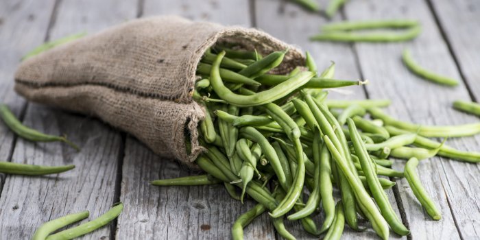 some green beans on wooden background
