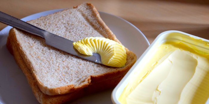 spreading margarine butter onto bread