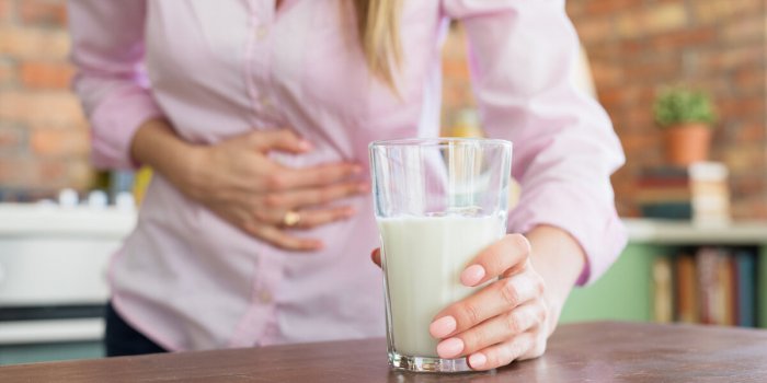 woman having pain in stomach, feeling sick by drinking milk