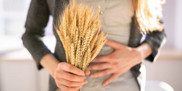 celiac disease and gluten intolerance women holding spikelet of wheat