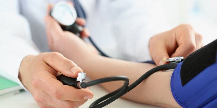 close-up of doctor check blood pressure of patient in clinic, risk of hypertension, prevent disease work with stethoscope...