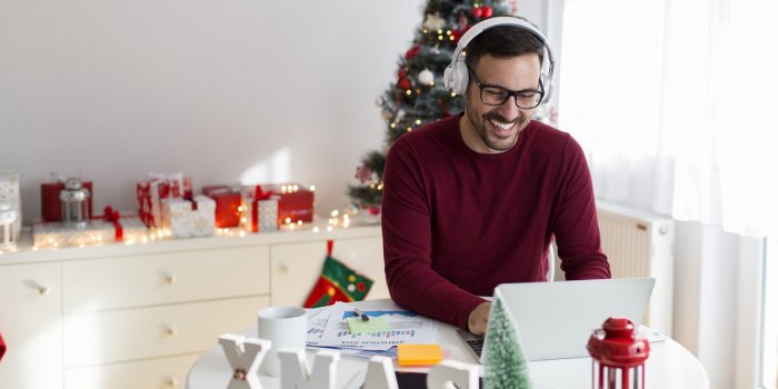 young man studying at home for christmas holidays