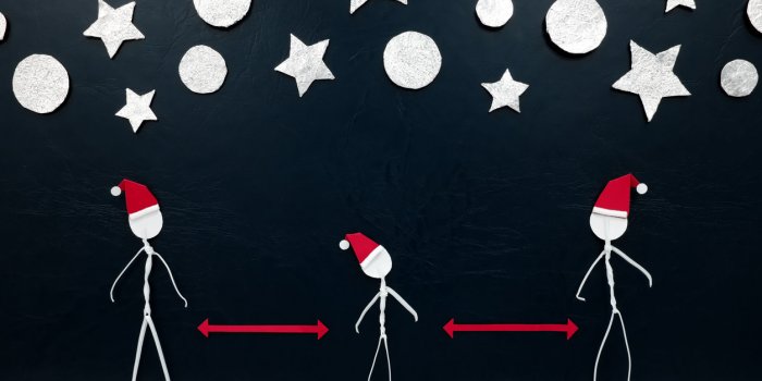 stick men figure wearing santa hat with red distance marker in between and silver stars and balls ornament background soc...