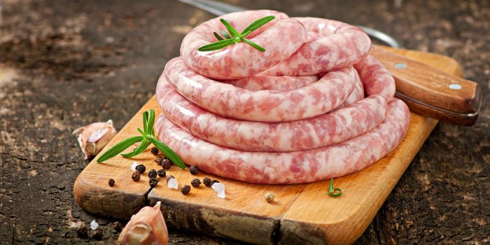 fresh raw sausage on the old wooden background