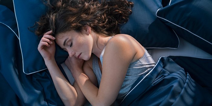 top view of young woman sleeping on side in her bed at night beautiful girl sleeping profoundly and dreaming at home with...