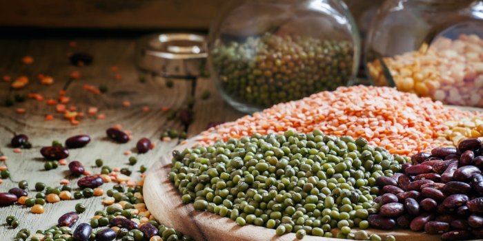green lentils on a vintage wooden background, mixed beans, selective focus
