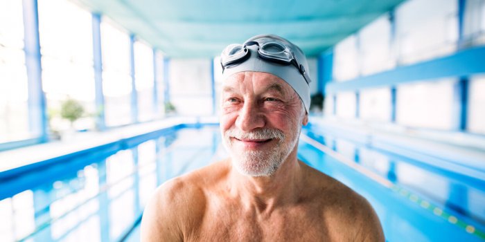 senior man in an indoor swimming pool active pensioner enjoying sport