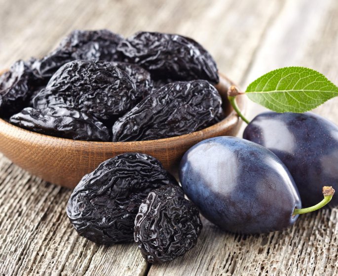 plum with prunes on a wooden board