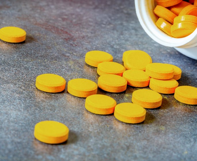 closeup on turmeric tablets, a natural food supplement with multiple virtues