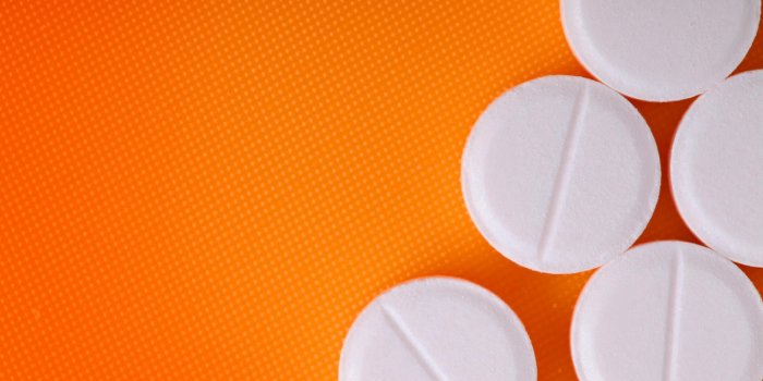 white pills on an orange background
