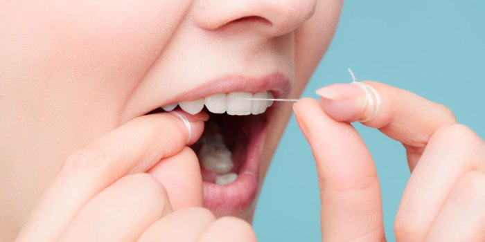 oral hygiene and health care smiling women use dental floss white healthy teeth