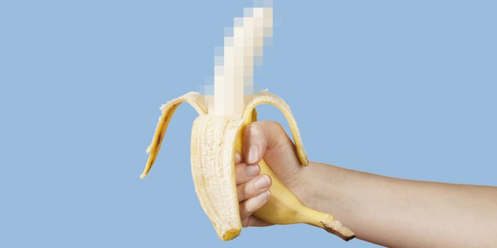 hidden censored banana in hand on a blue background horny (aroused) penis, male erection and sexual education funny porno...