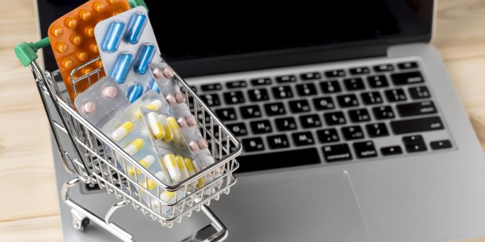 shopping cart with different tablets on notebook keyboard