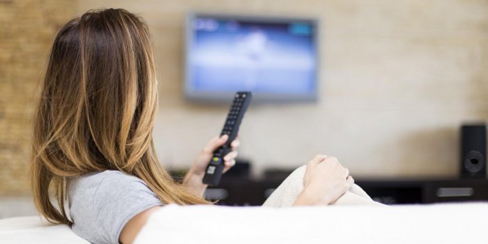 young woman watching tv in the room