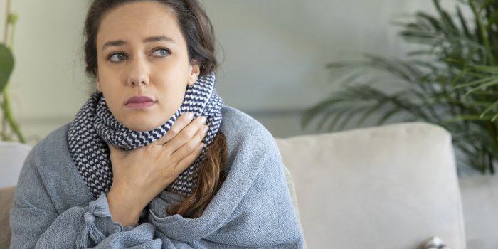 young woman touching painful neck, sore throat for flu, cold and infection