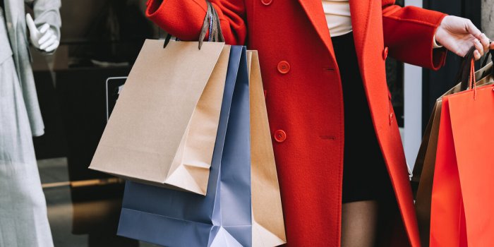 women's hands hold many shopping bags, sale season