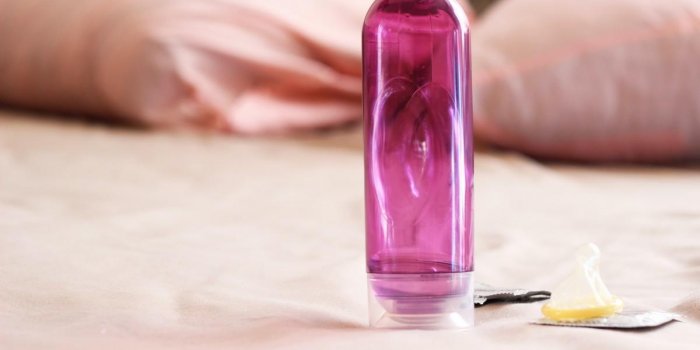 lubricant and condoms on the background of the bed comfortable sex sex education