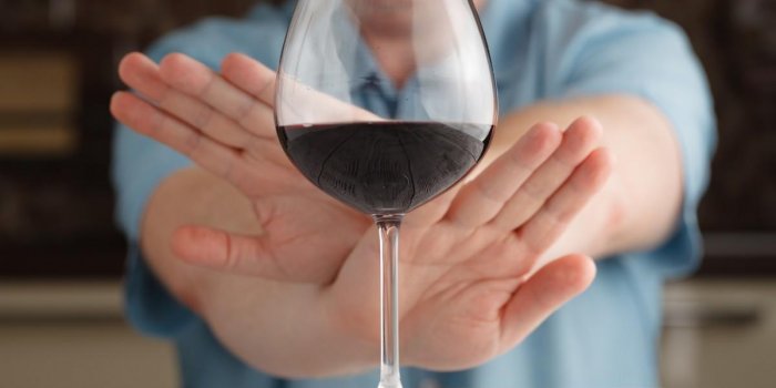 close-up of male hand reject a glass of wine offered