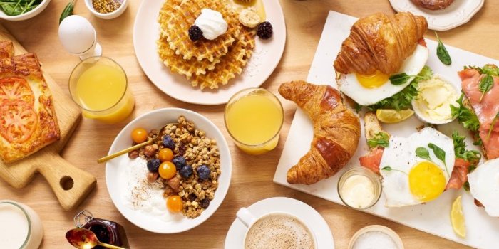 top view image of brunch menu on wooden table healthy sunday breakfast with croissants, waffles, granola and sandwiches f...