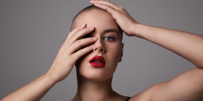 portrait of a beautiful and bald woman with red lips high quality photo