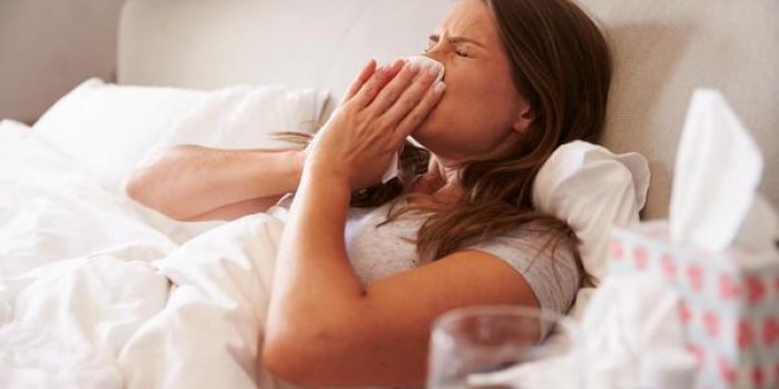 femme souffrant de froid couché dans son lit avec des tissus