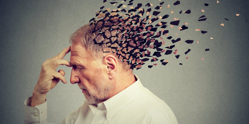 memory loss due to dementia senior man losing parts of head as symbol of decreased mind function