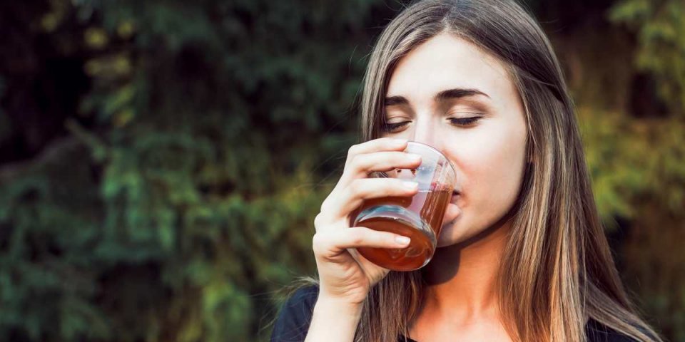 beautiful girl is drinking juice