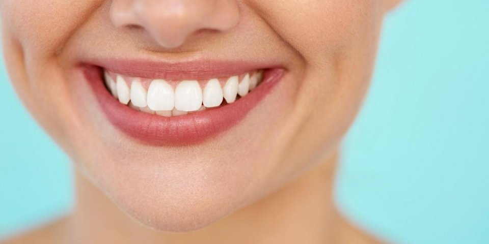 beautiful smile with white teeth closeup of smiling woman mouth with natural plump full lips and healthy perfect smile te...