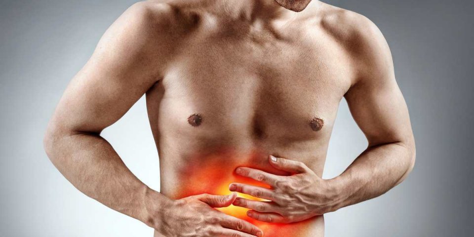 man holding his stomach in pain photo of man with naked torso experience stomachaches on grey background medical concept