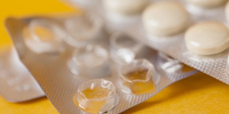 medicine concept tablets on yellow close up macro photo on yellow background